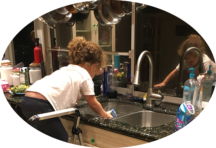 Aliyah Rose scrubs the kitchen sink